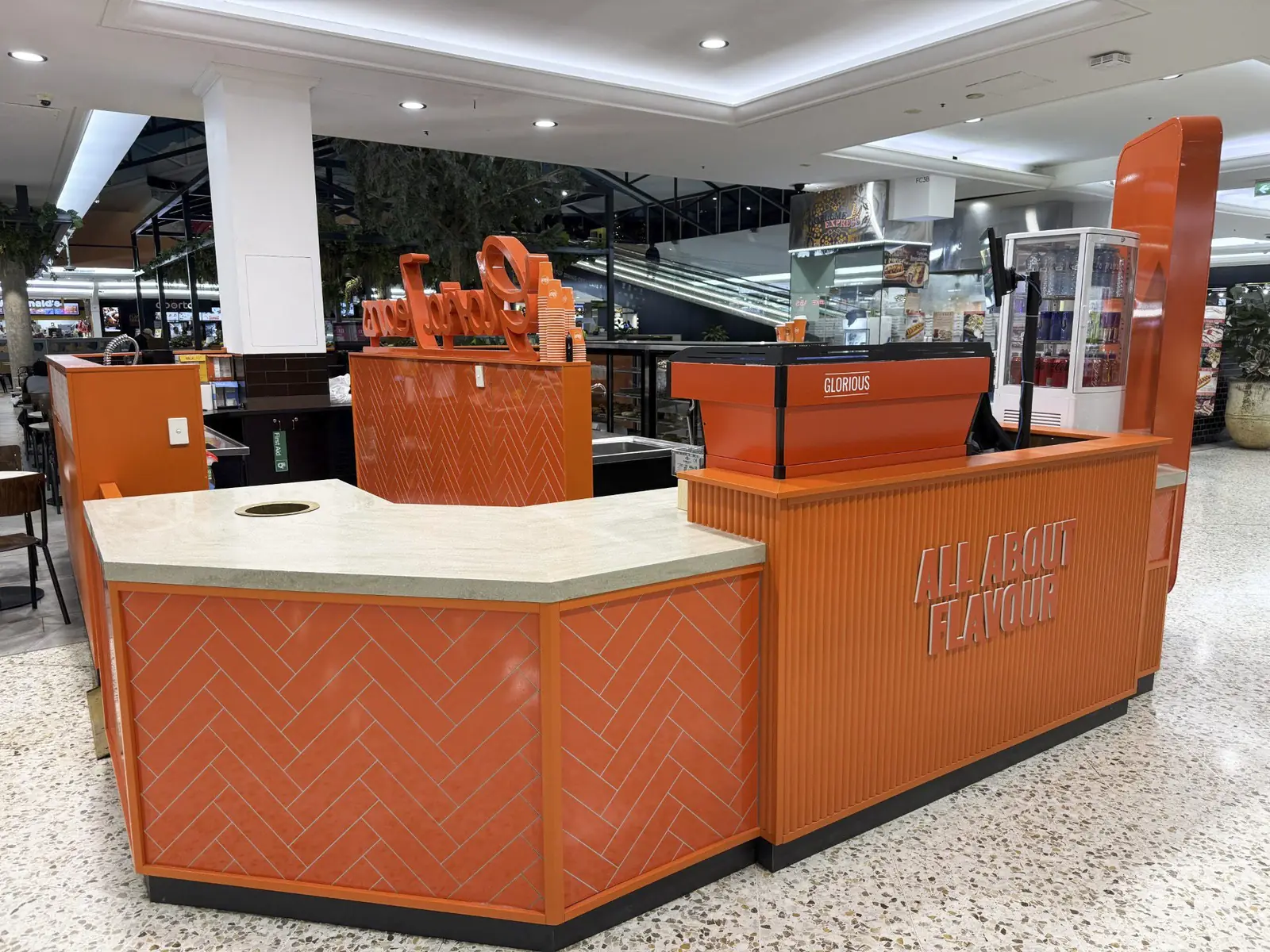 Gloria Jean's Mt Druitt kiosk counter with orange tile cladding