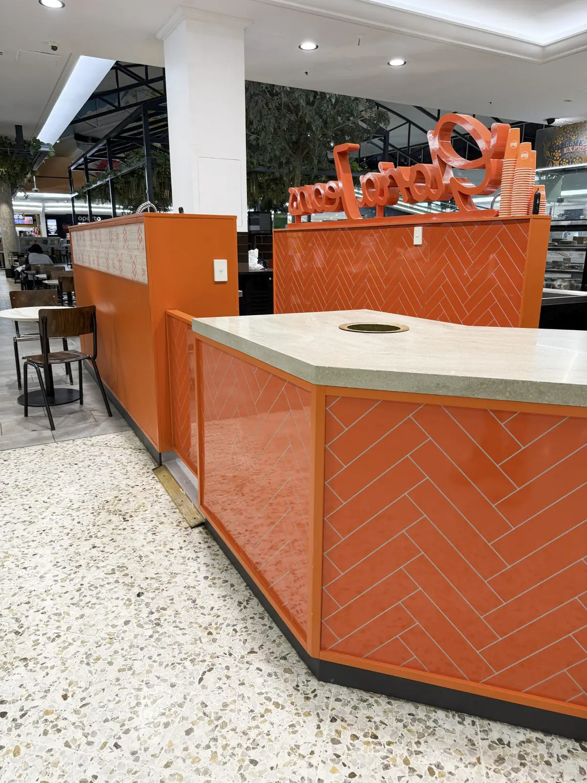 Glossy orange herringbone tile cladding on the Gloria Jean's Mt Druitt kiosk counter