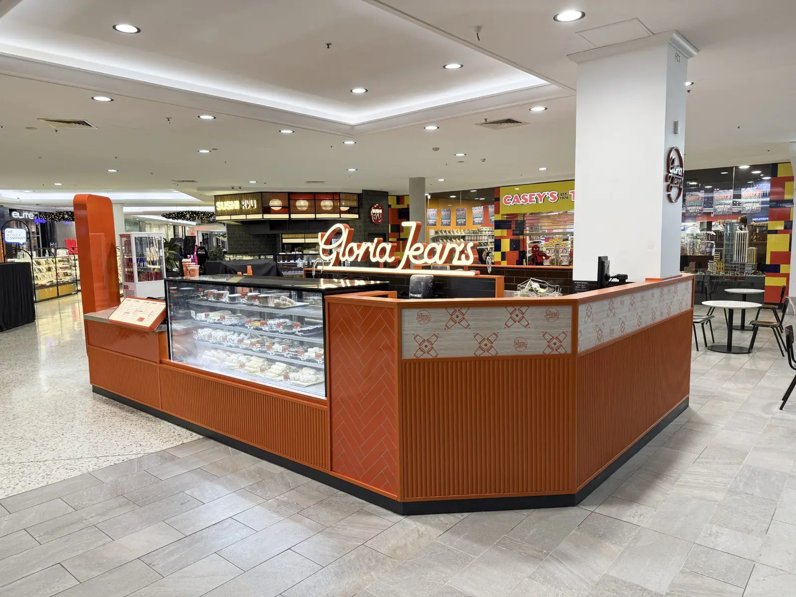Gloria Jean's kiosk at Mt Druitt with fluted orange panelling and illuminated script signage