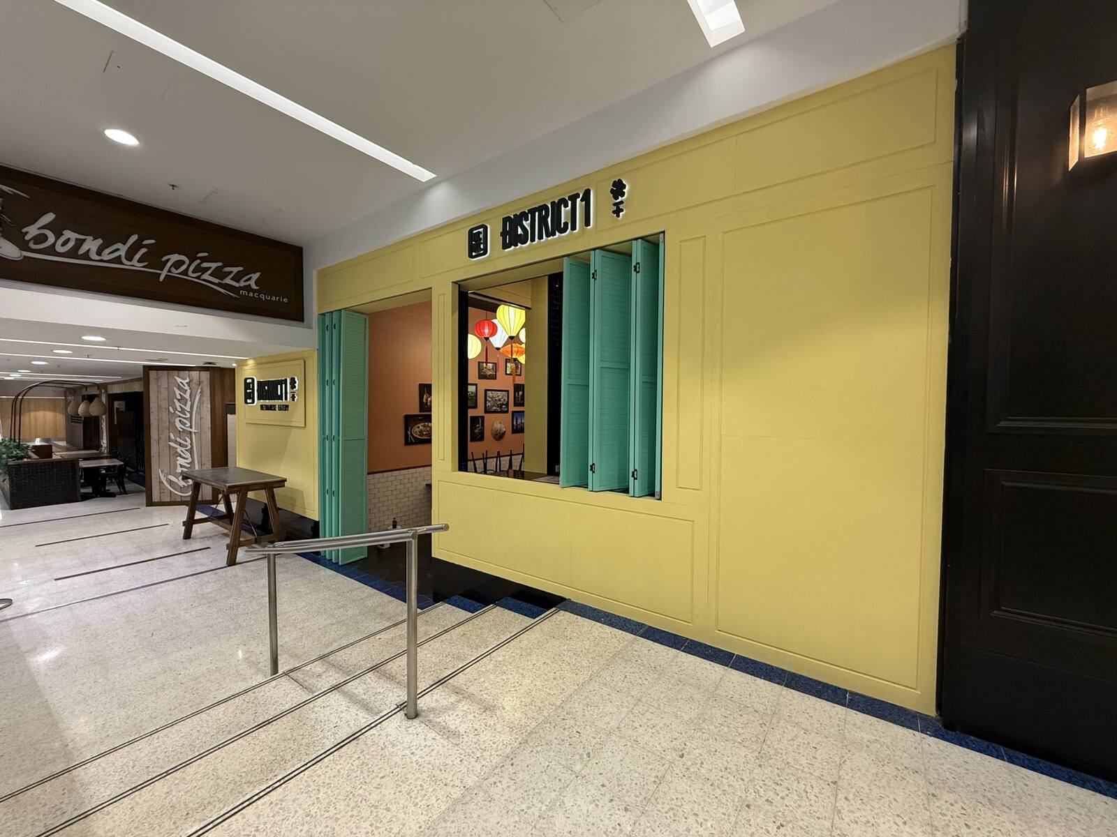 Wide view of the District 1 shopfront within a busy Sydney shopping centre corridor